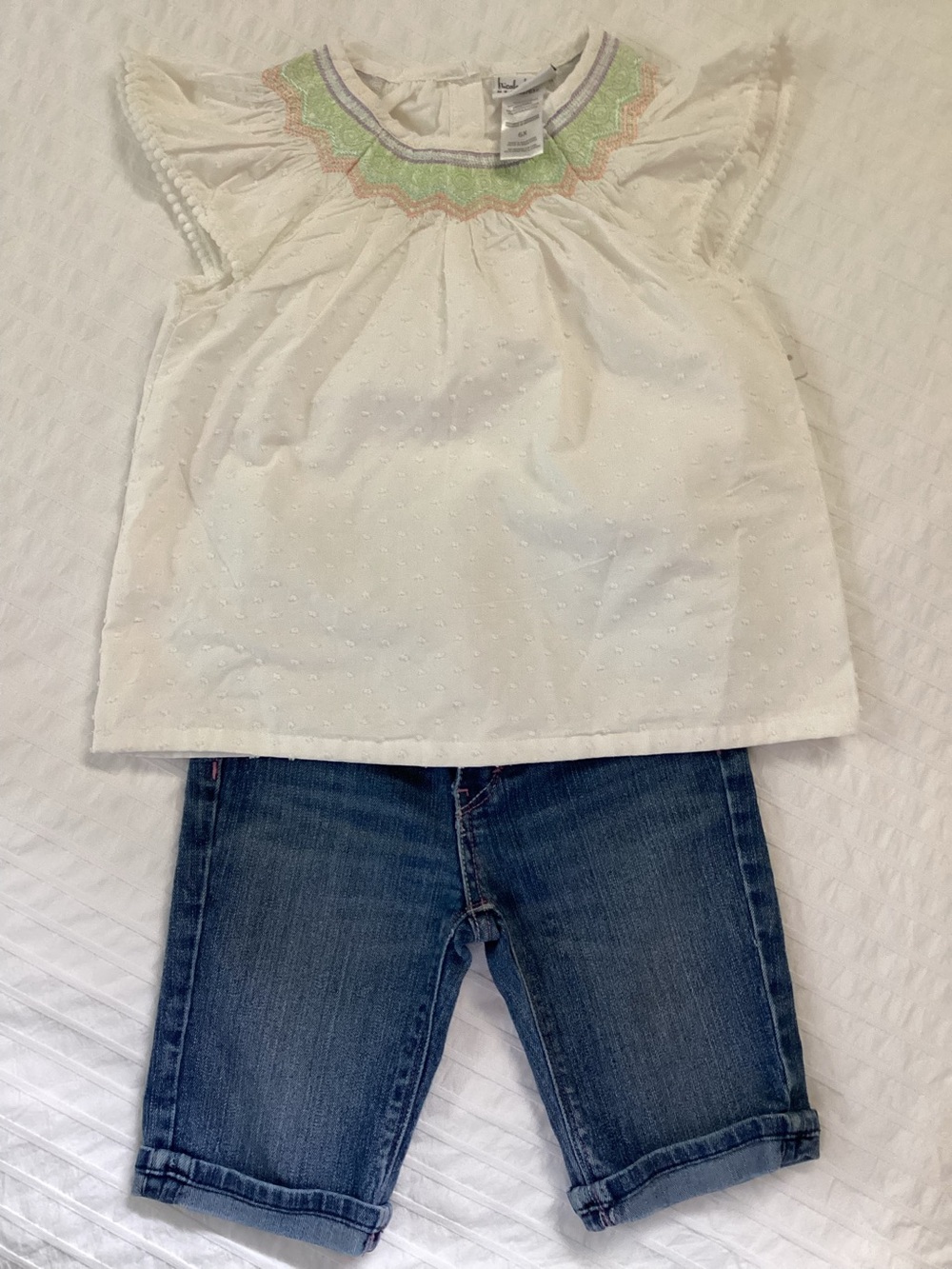 Nicole Miller White Flutter Sleeve Top with Pastel Embroidery and Levi’s shorts